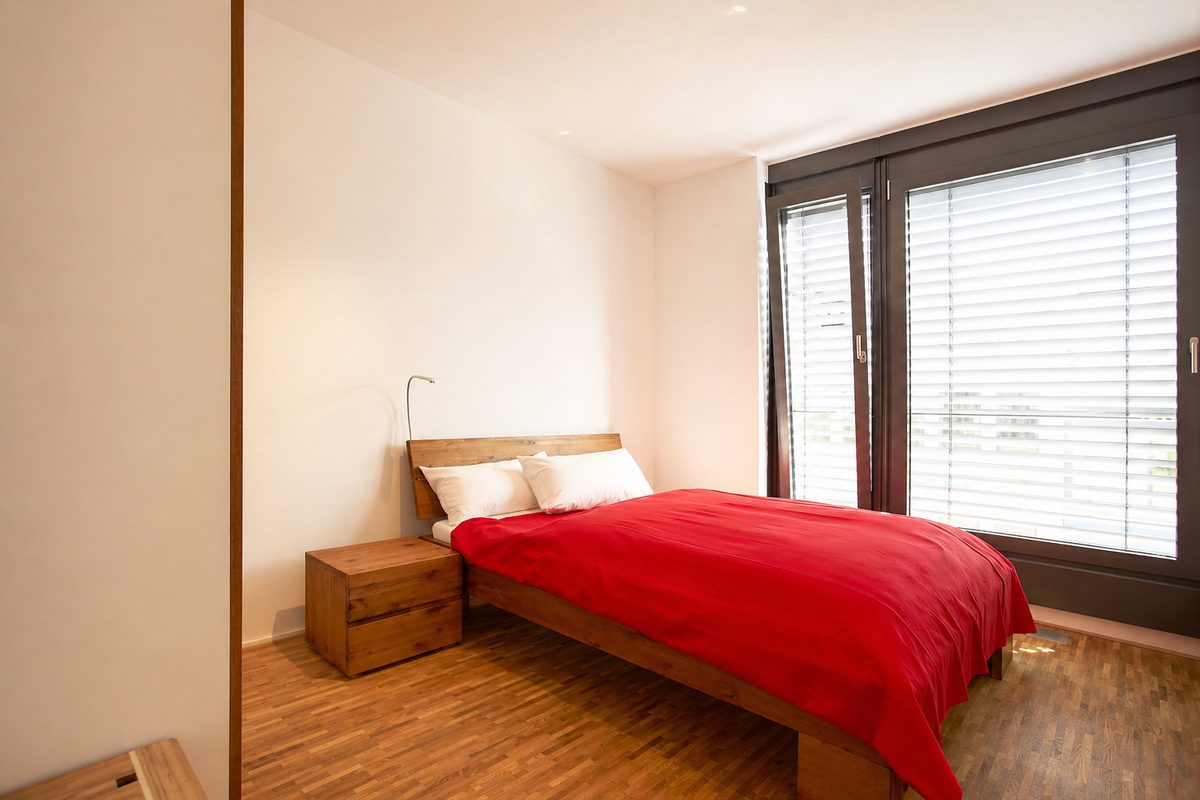 Bedroom with queen-size bed and blinds