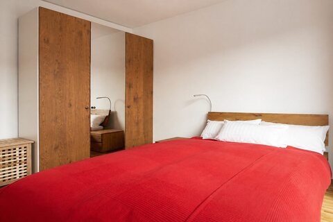 Queen-size bed and large wardrobe in bedroom