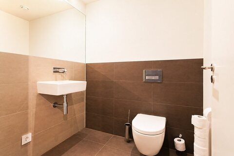 Second bathroom with sink and toilet