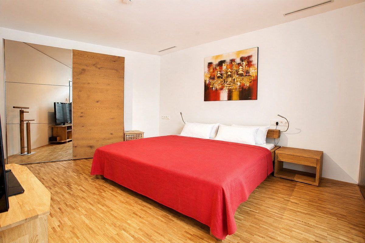 Main bedroom with king bed and large mirror closet