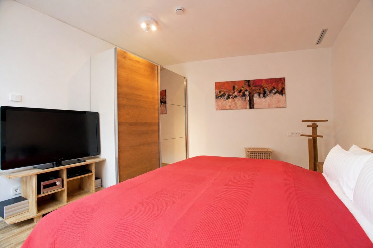 Master bedroom with TV and wardrobe