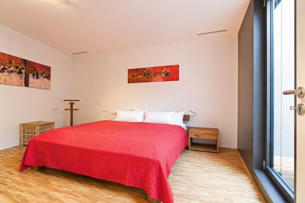 Master bedroom with king bed next to private patio