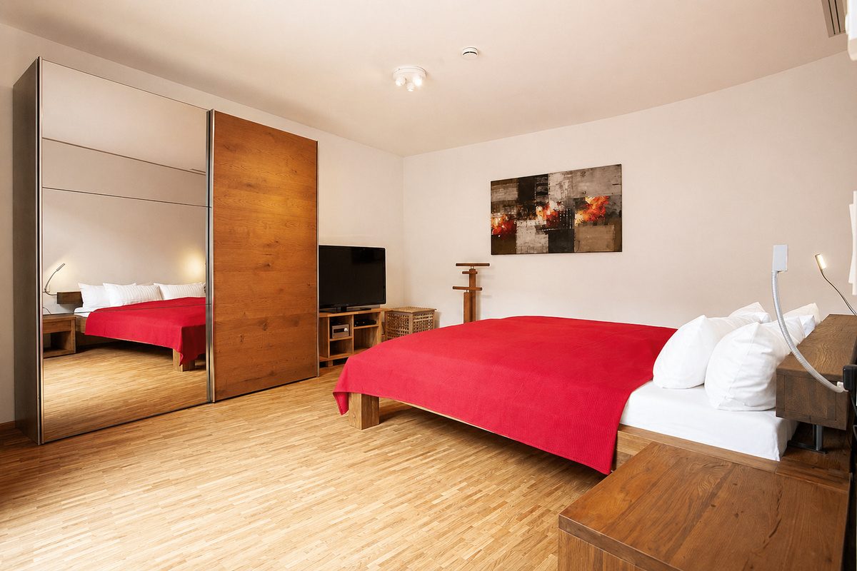 Bedroom with king bed and mirror wardrobe