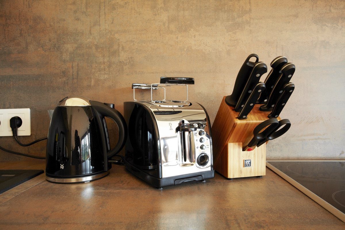 Knife block, kettle and toaster on counter