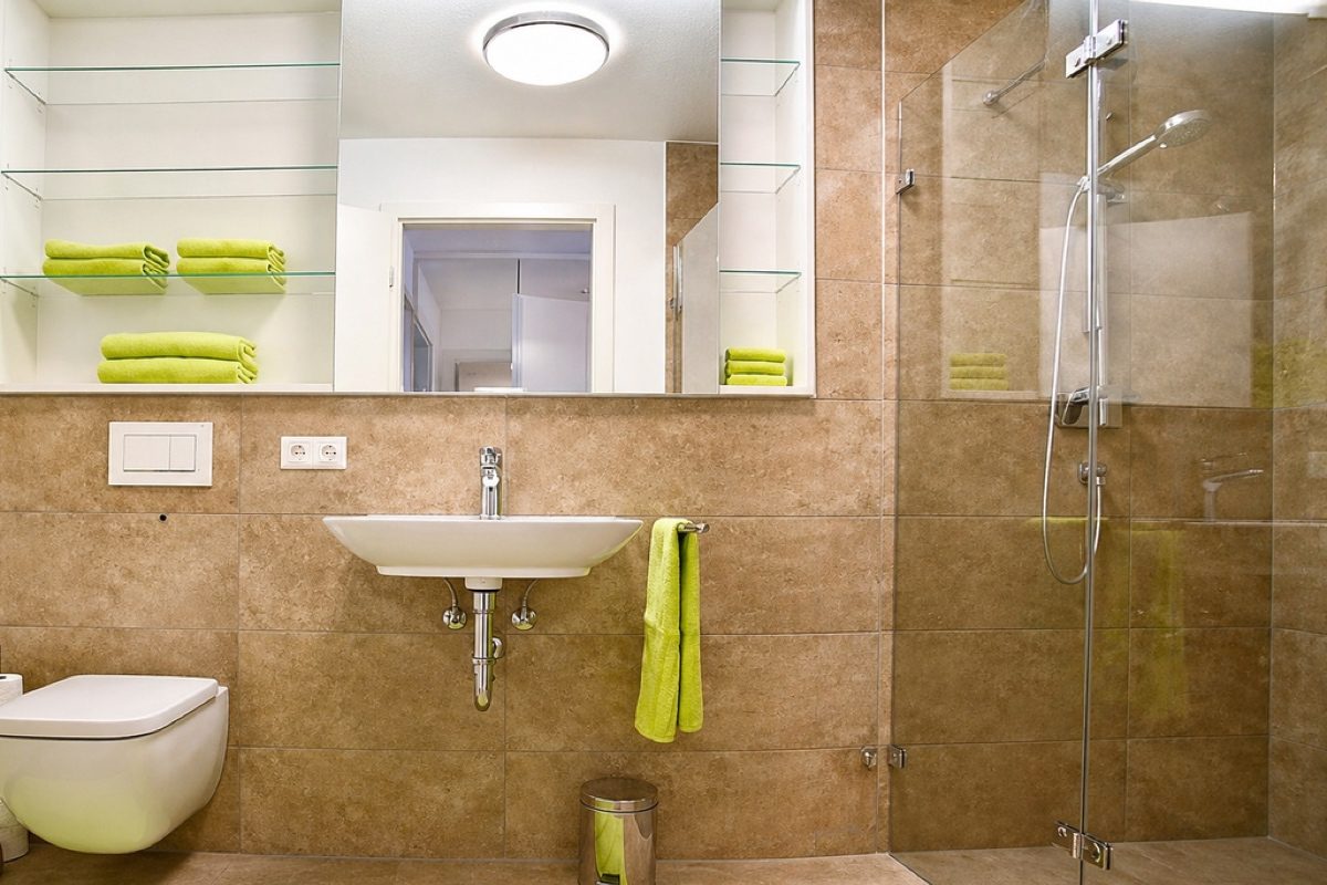 Bathroom with toilet, sink and glass shower