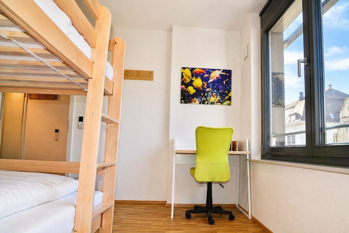 Bunk bed and desk in smaller bedroom