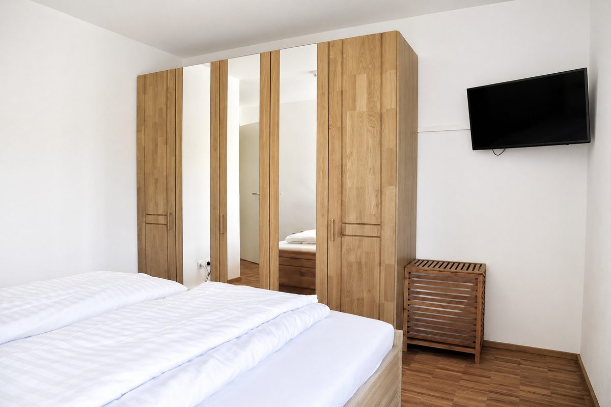 Master bedroom with king bed, wardrobe and TV