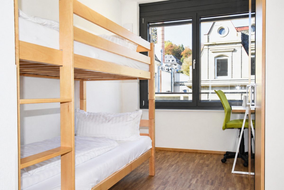 Small bedroom with bunk bed and desk