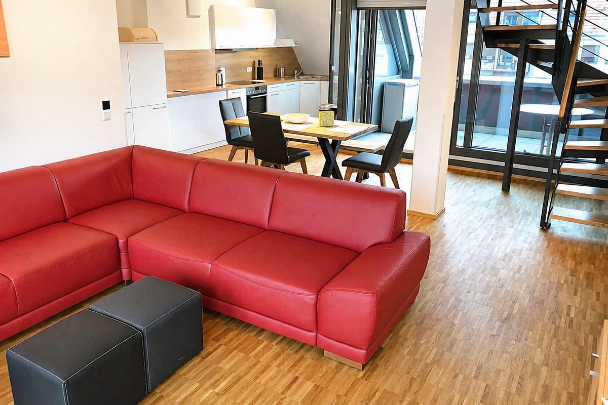 Apartment living area with couch and dining table