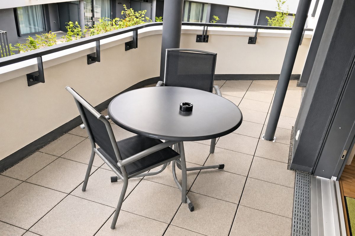 Apartment balcony with table and chairs