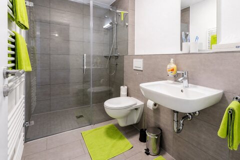 Bathroom with glass shower, toilet and sink