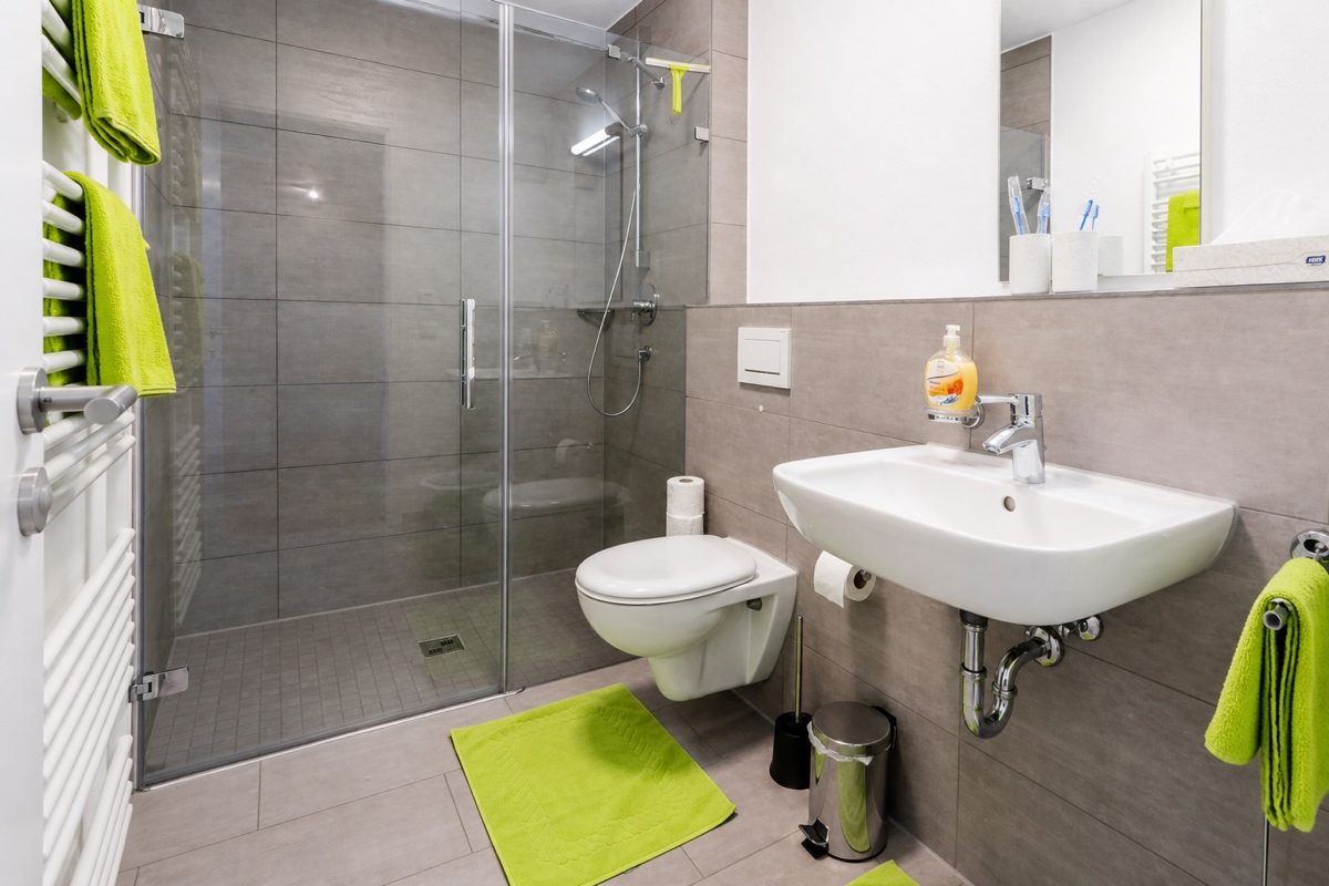 Bathroom with glass shower, toilet and sink