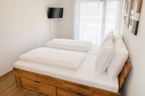 Master bedroom with king-size bed and TV