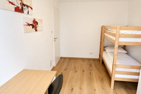 Second bedroom with bunk bed and desk