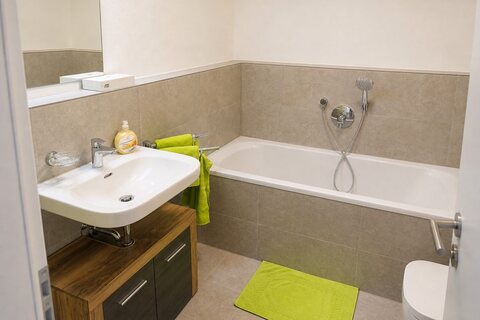 En suite Bathroom with bathtub, sink and toilet