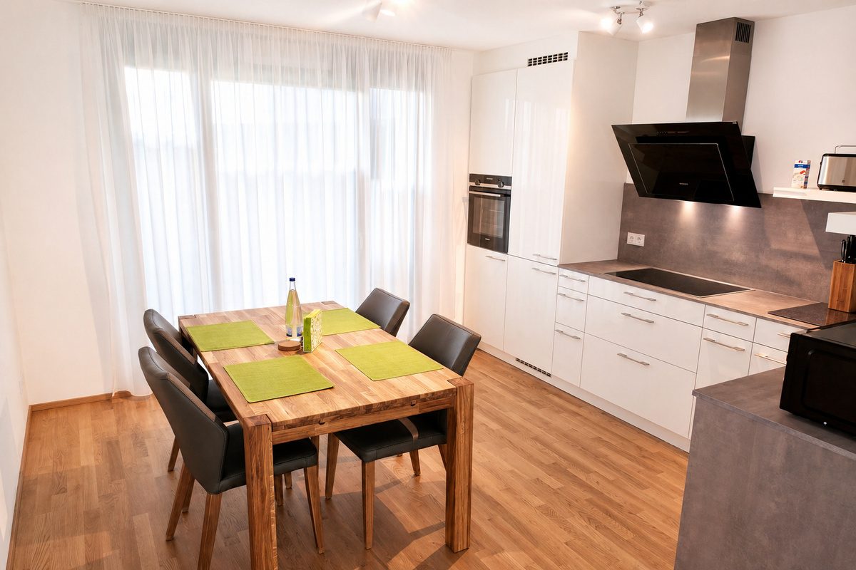 Dining area with open kitchen in furnished apartment