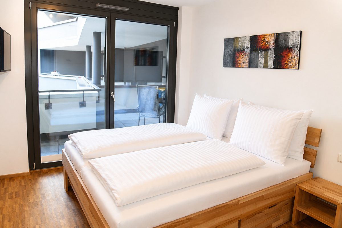 Bedroom with king-size bed and balcony access