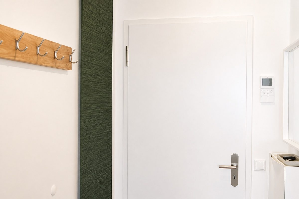 Entryway with video intercom, coat rack and storage room