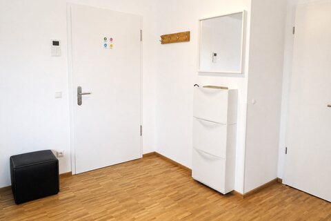 Entryway with video intercom, shoe cabinet and storage room