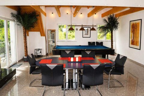 Dining area with pool table in luxury penthouse