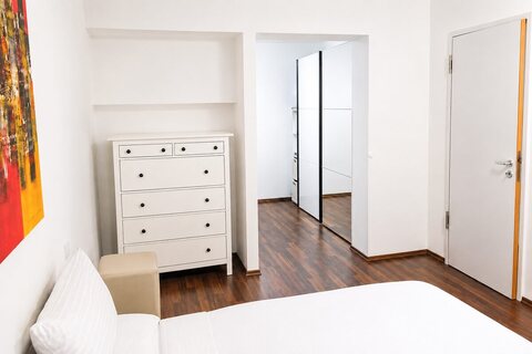 Master bedroom with dresser and wardrobe